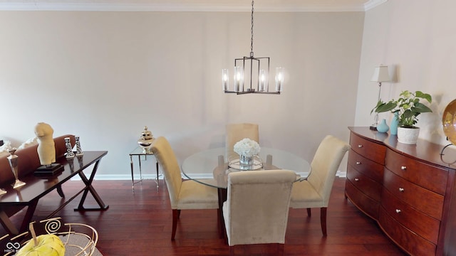 dining space featuring dark wood finished floors, crown molding, baseboards, and a chandelier