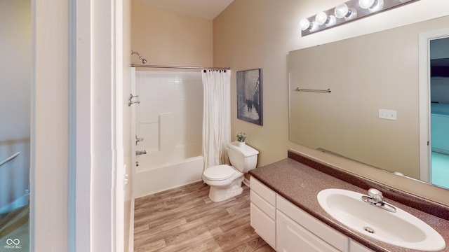 full bath with toilet, vanity, shower / tub combo with curtain, and wood finished floors