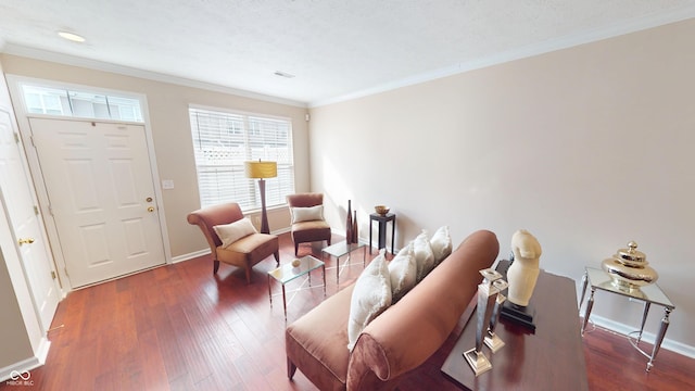 living room featuring crown molding, wood finished floors, baseboards, and visible vents