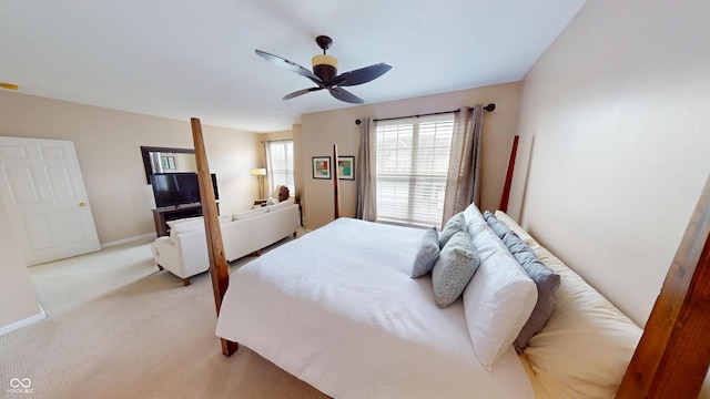 bedroom with ceiling fan, baseboards, and light carpet