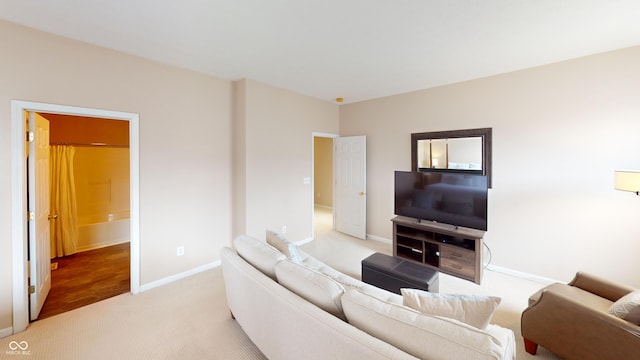 living room with baseboards and light carpet