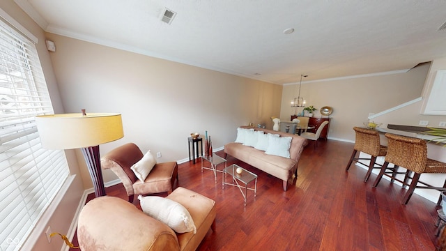 living area featuring baseboards, visible vents, dark wood-style flooring, ornamental molding, and a notable chandelier