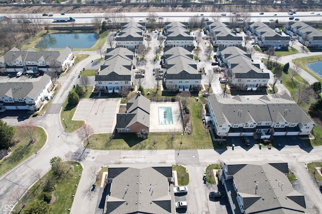 birds eye view of property with a residential view and a water view