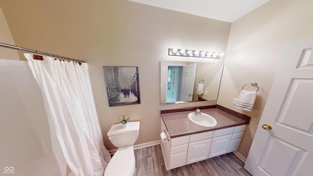 bathroom featuring vanity, a shower with curtain, toilet, and wood finished floors