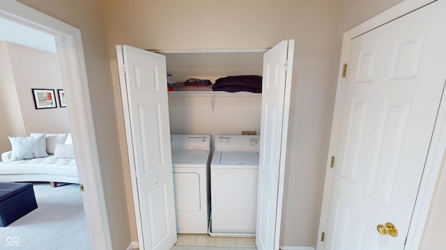 laundry room with light colored carpet, laundry area, and washer and clothes dryer