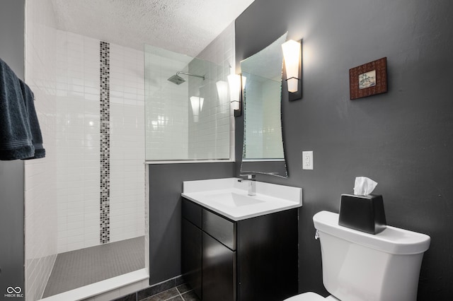 bathroom featuring a walk in shower, toilet, vanity, and a textured ceiling