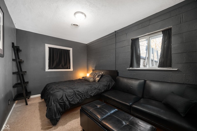 bedroom featuring visible vents, baseboards, carpet, and a textured ceiling