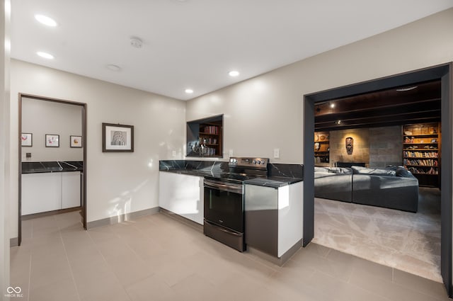 kitchen with white cabinetry, dark countertops, stainless steel electric stove, and recessed lighting