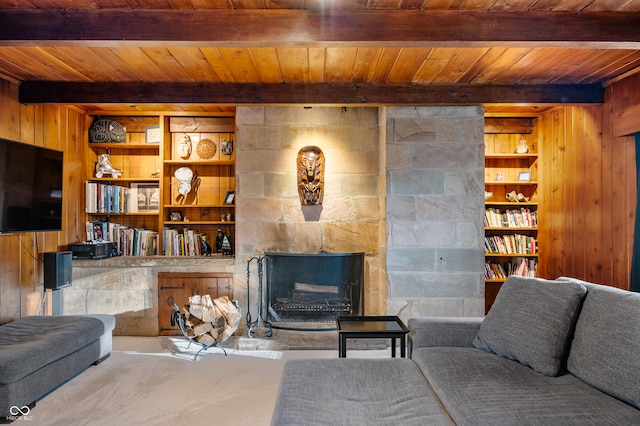 living room featuring built in shelves, beam ceiling, wooden ceiling, and wood walls