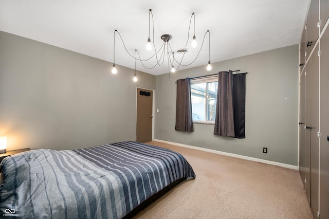 carpeted bedroom with a closet and baseboards