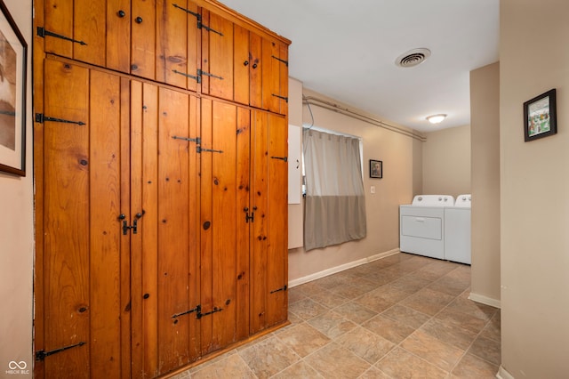 interior space with visible vents, baseboards, and independent washer and dryer