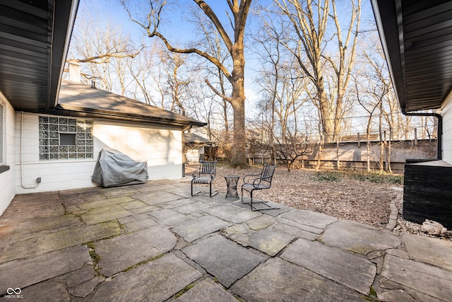 view of patio featuring a grill and fence