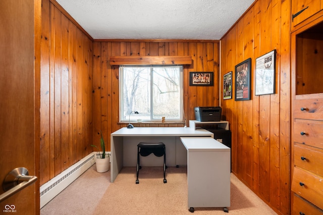 home office with a baseboard heating unit, wooden walls, light colored carpet, and a textured ceiling