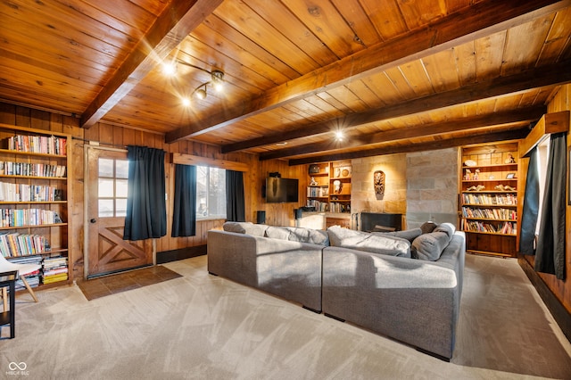 living area with wooden walls, built in features, wooden ceiling, beamed ceiling, and carpet flooring