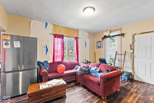 living room with a textured ceiling and wood finished floors