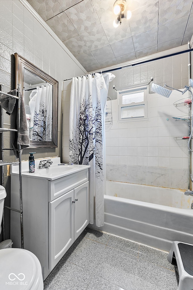 bathroom with toilet, shower / bathtub combination with curtain, and vanity