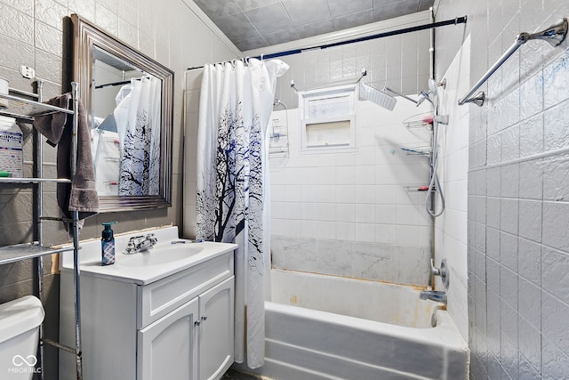 bathroom with toilet, shower / bath combo with shower curtain, and vanity