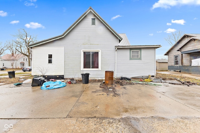 back of property featuring metal roof