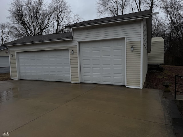 garage with concrete driveway