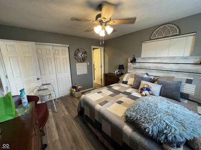 bedroom featuring a textured ceiling, wood finished floors, a ceiling fan, baseboards, and a closet