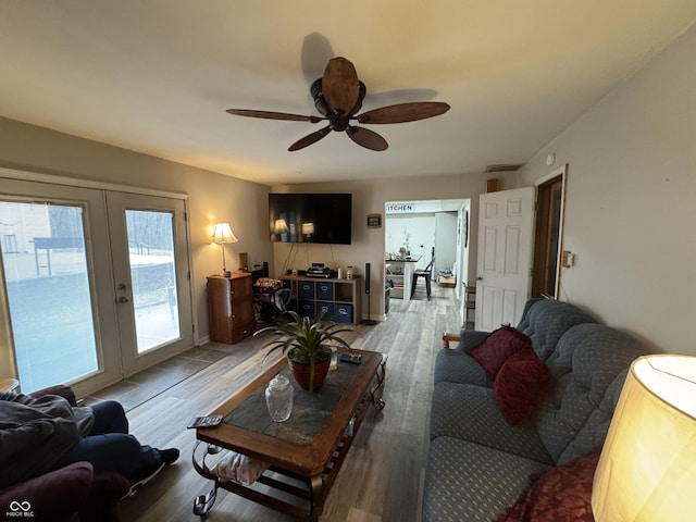 living room with visible vents, french doors, a ceiling fan, and light wood-style floors