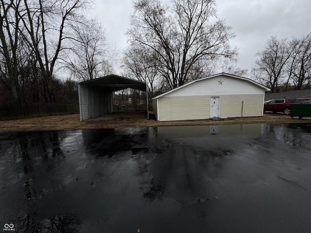 garage featuring driveway and a detached carport