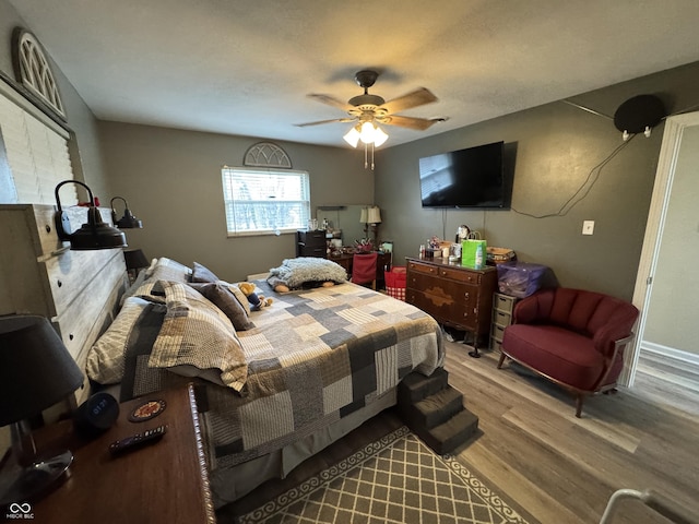 bedroom featuring ceiling fan and wood finished floors