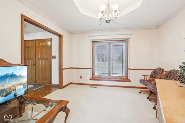 office with an inviting chandelier, visible vents, a tray ceiling, and ornamental molding