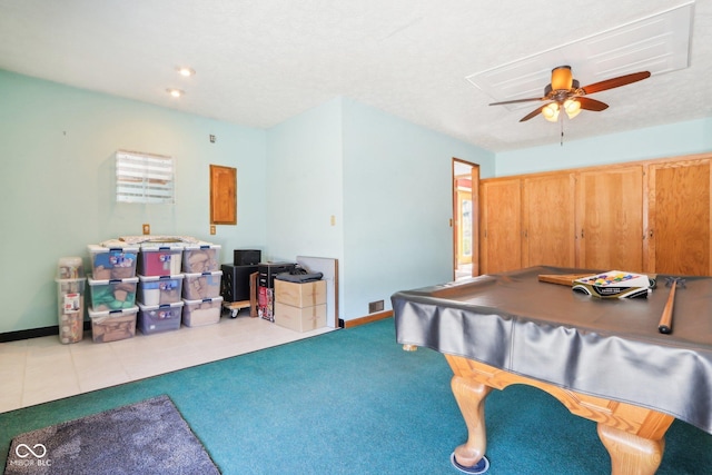 playroom with a ceiling fan, visible vents, baseboards, carpet floors, and tile patterned flooring