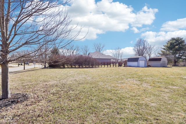 view of yard featuring an outbuilding and a storage shed