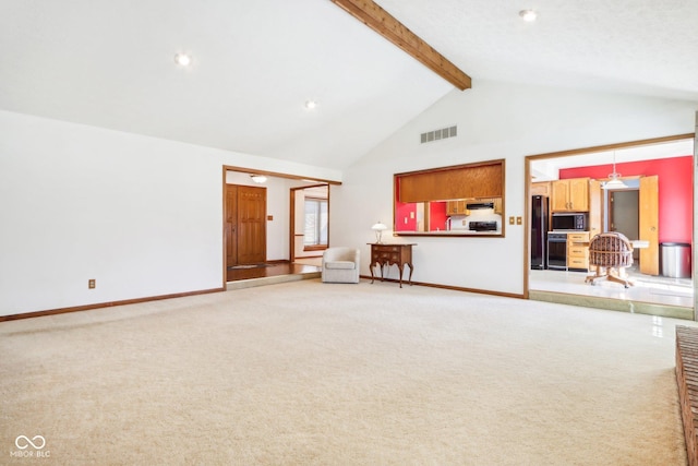 unfurnished living room with visible vents, beamed ceiling, high vaulted ceiling, and light colored carpet