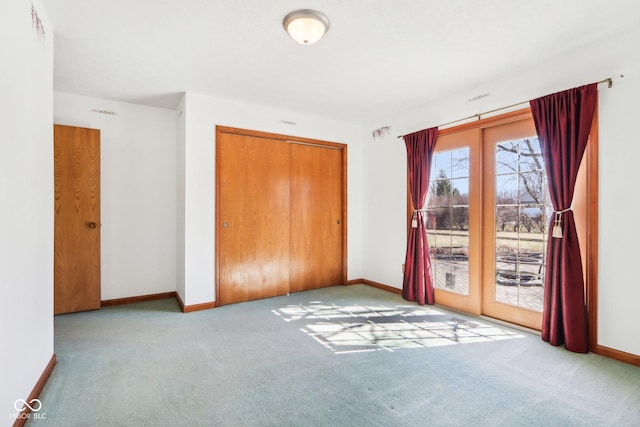 unfurnished bedroom with access to exterior, baseboards, carpet flooring, french doors, and a closet