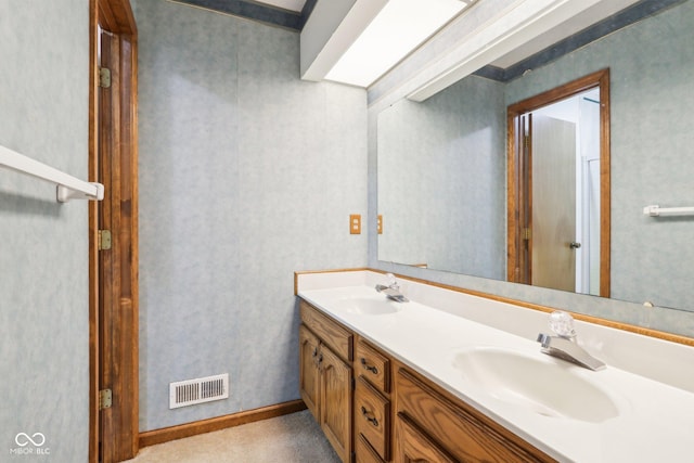 full bath with double vanity, visible vents, and a sink