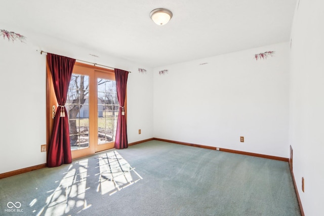 carpeted spare room with baseboards