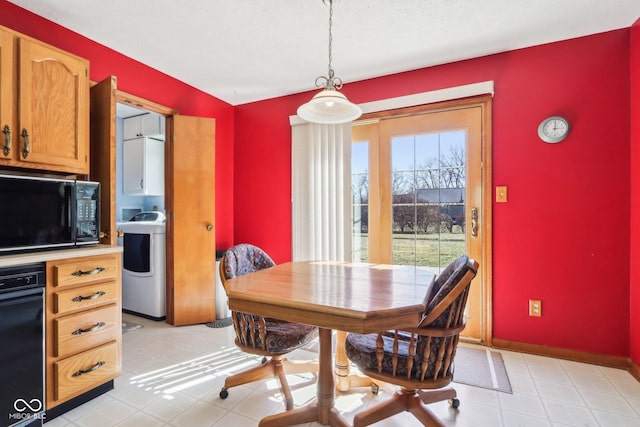 dining area with baseboards and washer / clothes dryer