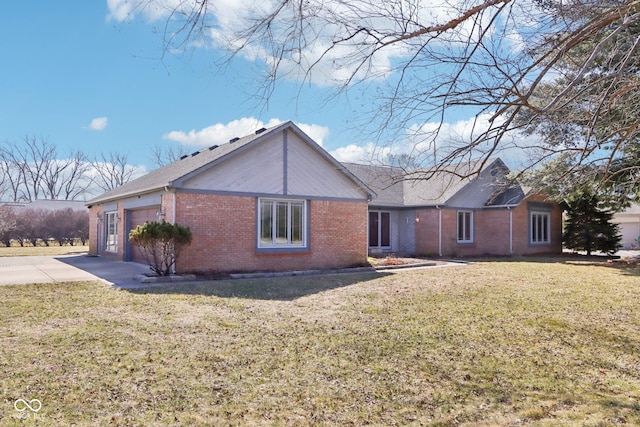 view of front facade featuring a garage, a front lawn, brick siding, and driveway