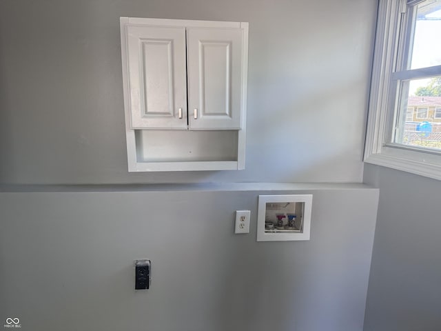 laundry area featuring hookup for a washing machine, cabinet space, and hookup for an electric dryer