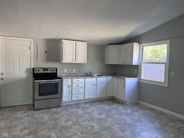 kitchen featuring stainless steel range with electric stovetop, baseboards, white cabinets, and a sink