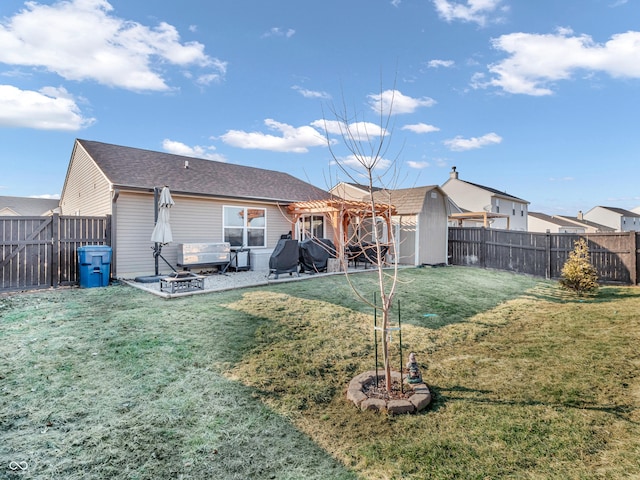 rear view of house with a patio area, a lawn, a pergola, and a fenced backyard