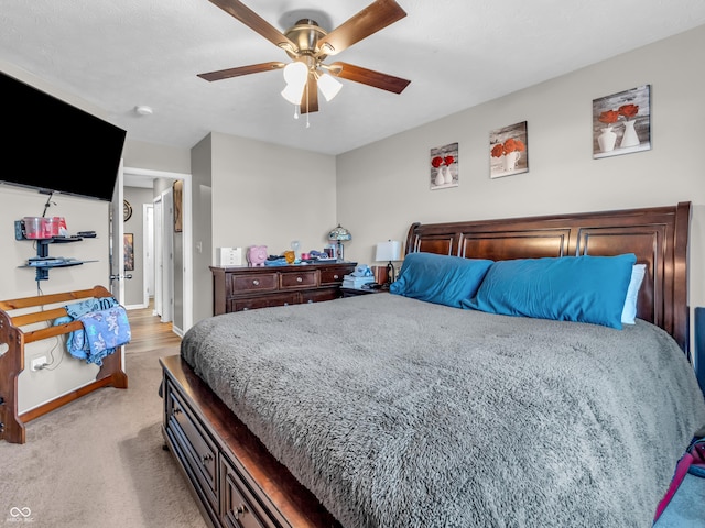 bedroom featuring baseboards, light carpet, and ceiling fan