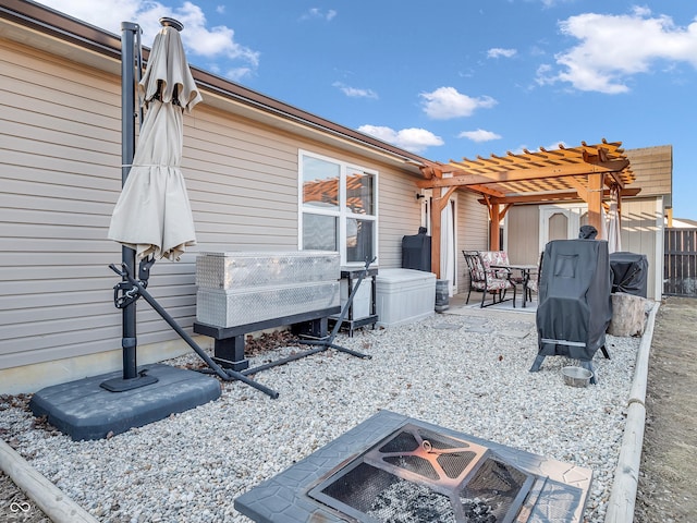 exterior space with an outdoor fire pit and a pergola