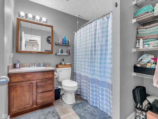 bathroom with curtained shower, toilet, vanity, and a textured ceiling