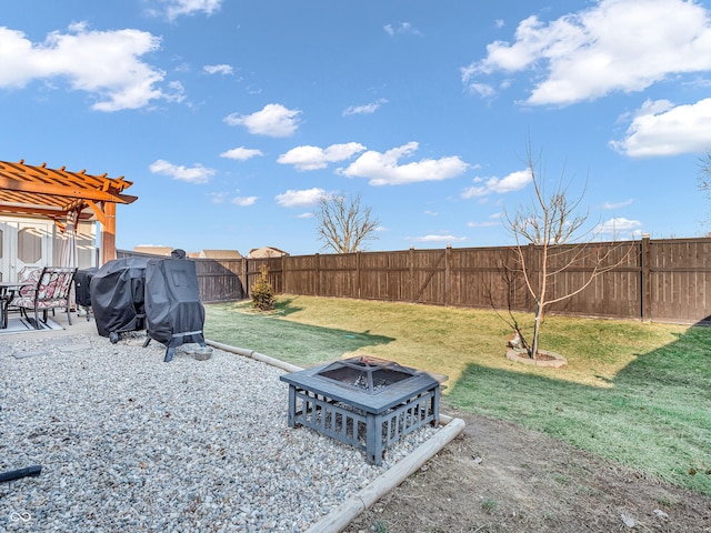 view of yard featuring a fire pit, a fenced backyard, a pergola, and a patio area