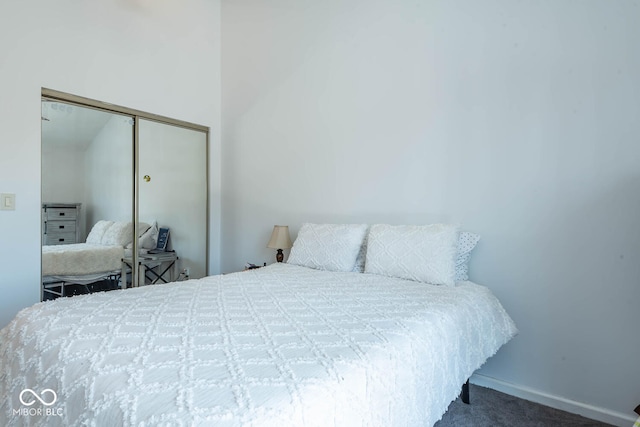 bedroom featuring carpet, a closet, and baseboards