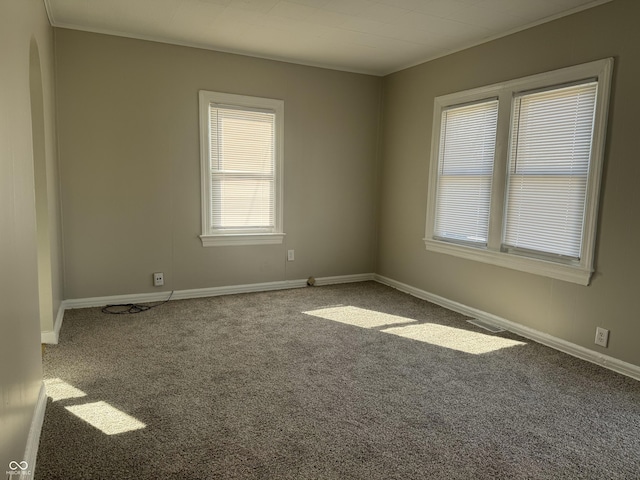 unfurnished room featuring carpet floors, ornamental molding, and baseboards