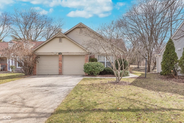 view of front of property featuring brick siding, driveway, a front lawn, and a garage