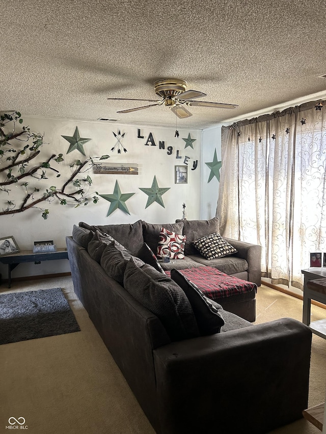 living room with carpet flooring, ceiling fan, and a textured ceiling