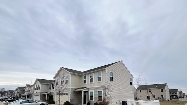 view of home's exterior with board and batten siding, a residential view, fence, and cooling unit