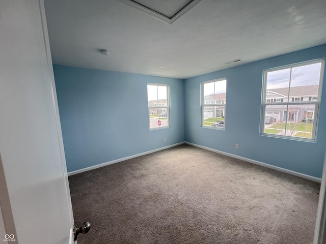 spare room with visible vents, baseboards, and carpet flooring
