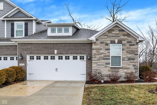 view of front facade featuring concrete driveway, a shingled roof, an attached garage, and stone siding